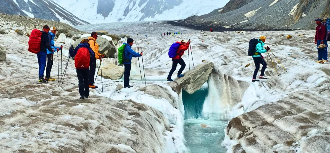 Trekkers are crossing baltoro glacier craves on day light.