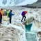 Trekkers are crossing baltoro glacier craves on day light.